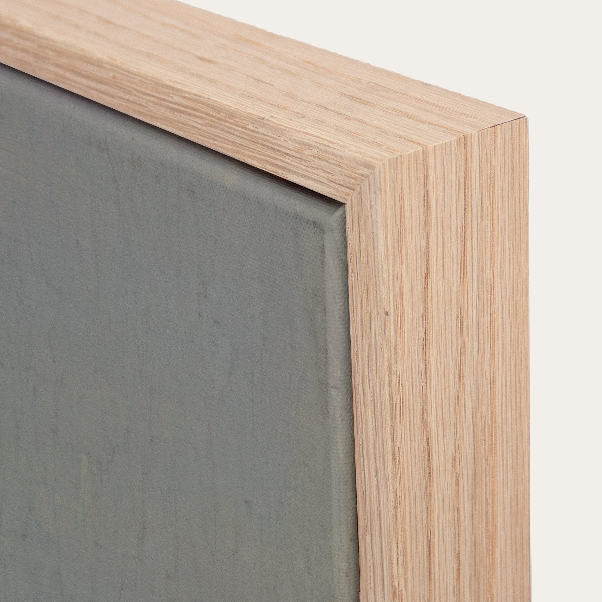 Close-up of a wooden frame corner with a gray background 