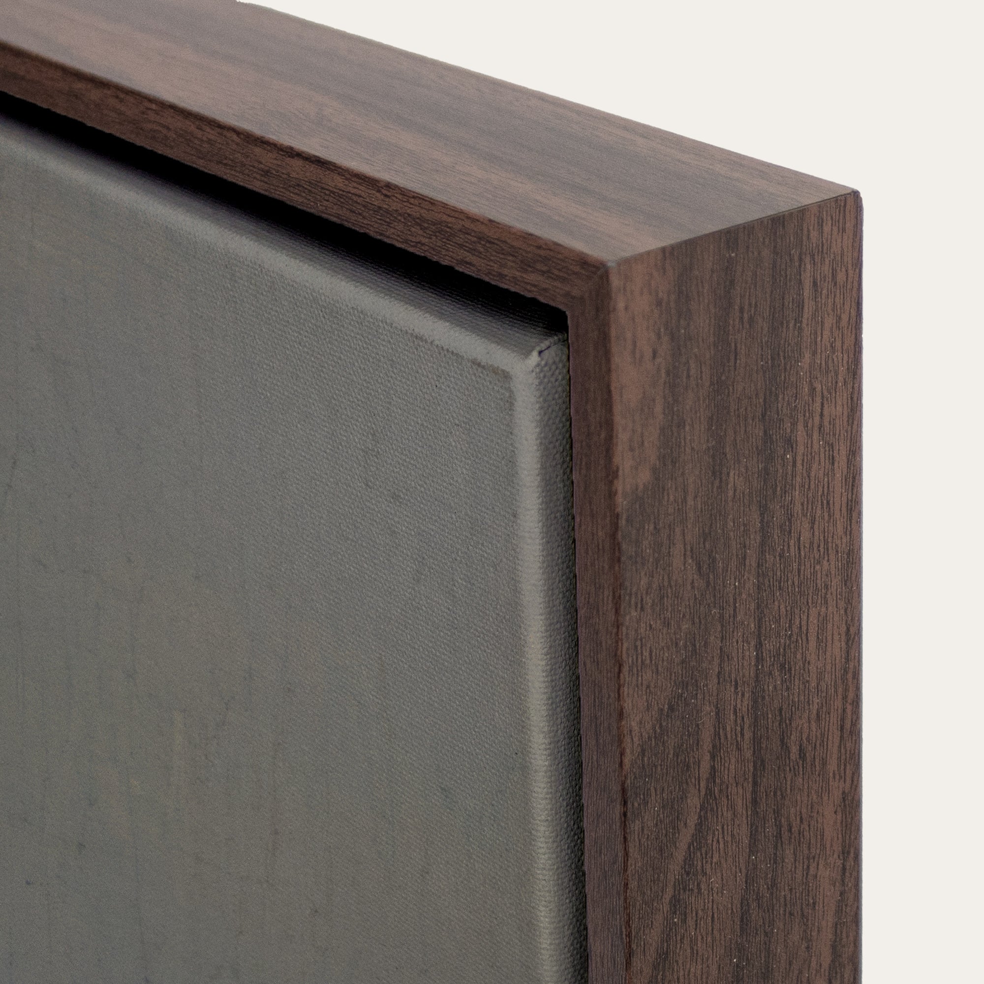 Close-up of a wooden frame corner on a gray background 