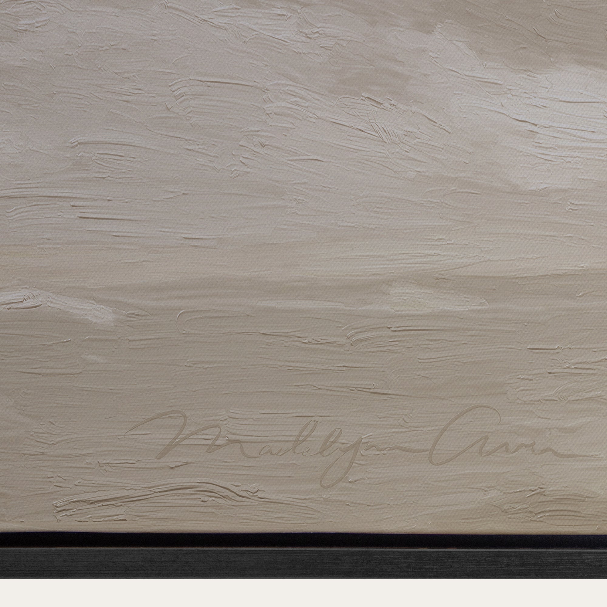Textured beige surface with a signature at the bottom 