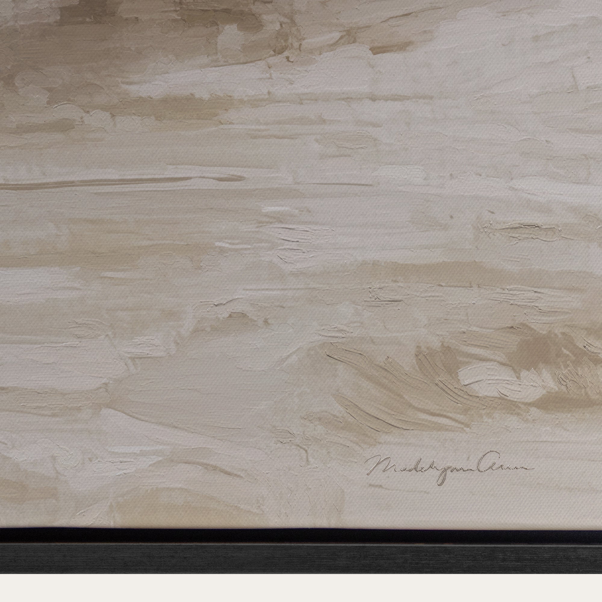 Textured beige surface with a signature at the bottom right corner 