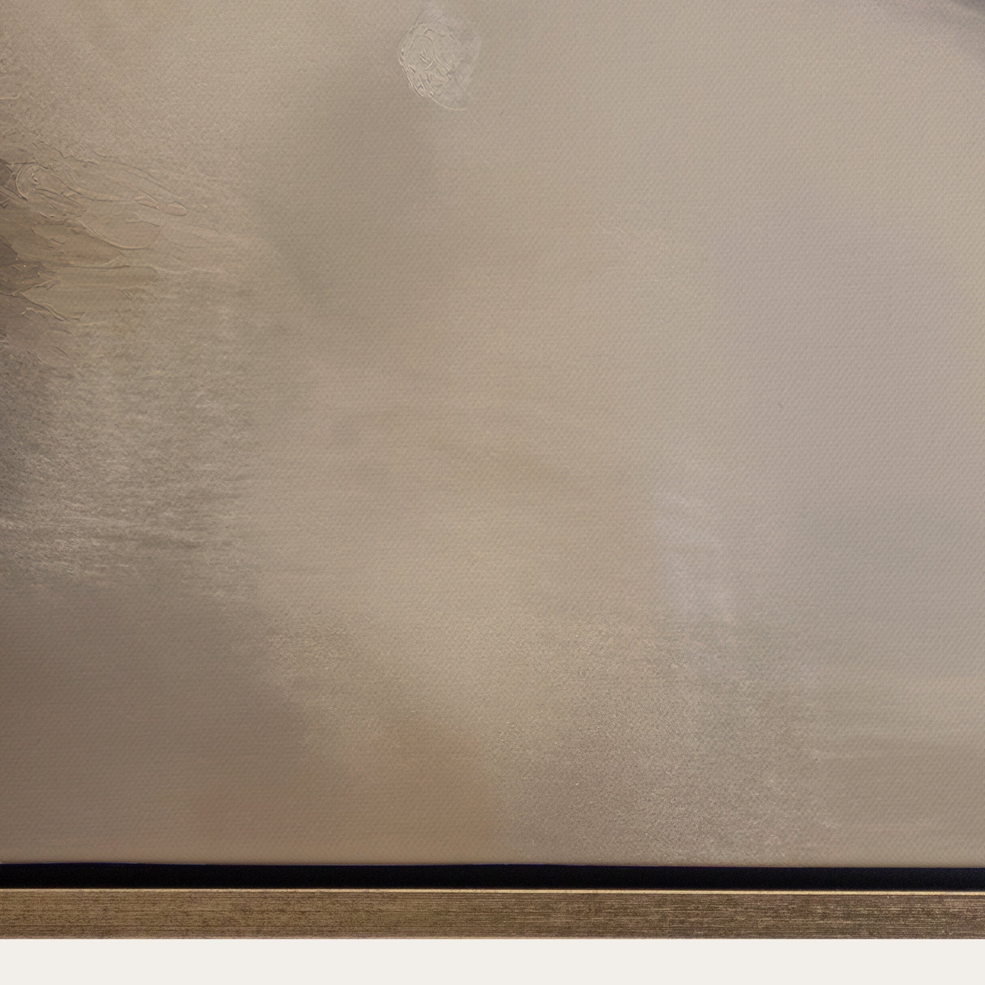 Textured beige surface with a black strip at the bottom 