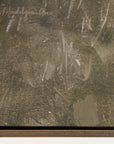 close-up of a textured surface with a signature in the top left corner. 