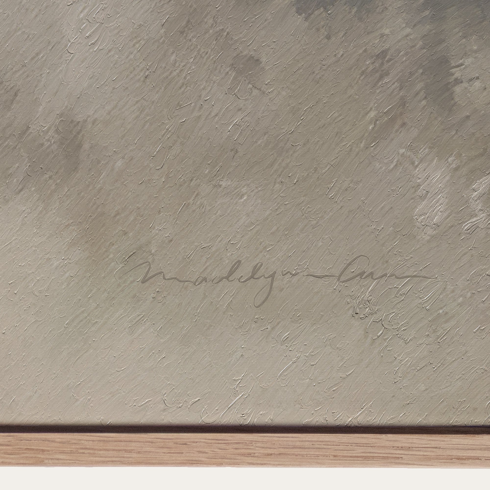 Textured beige surface with a signature and wooden base 