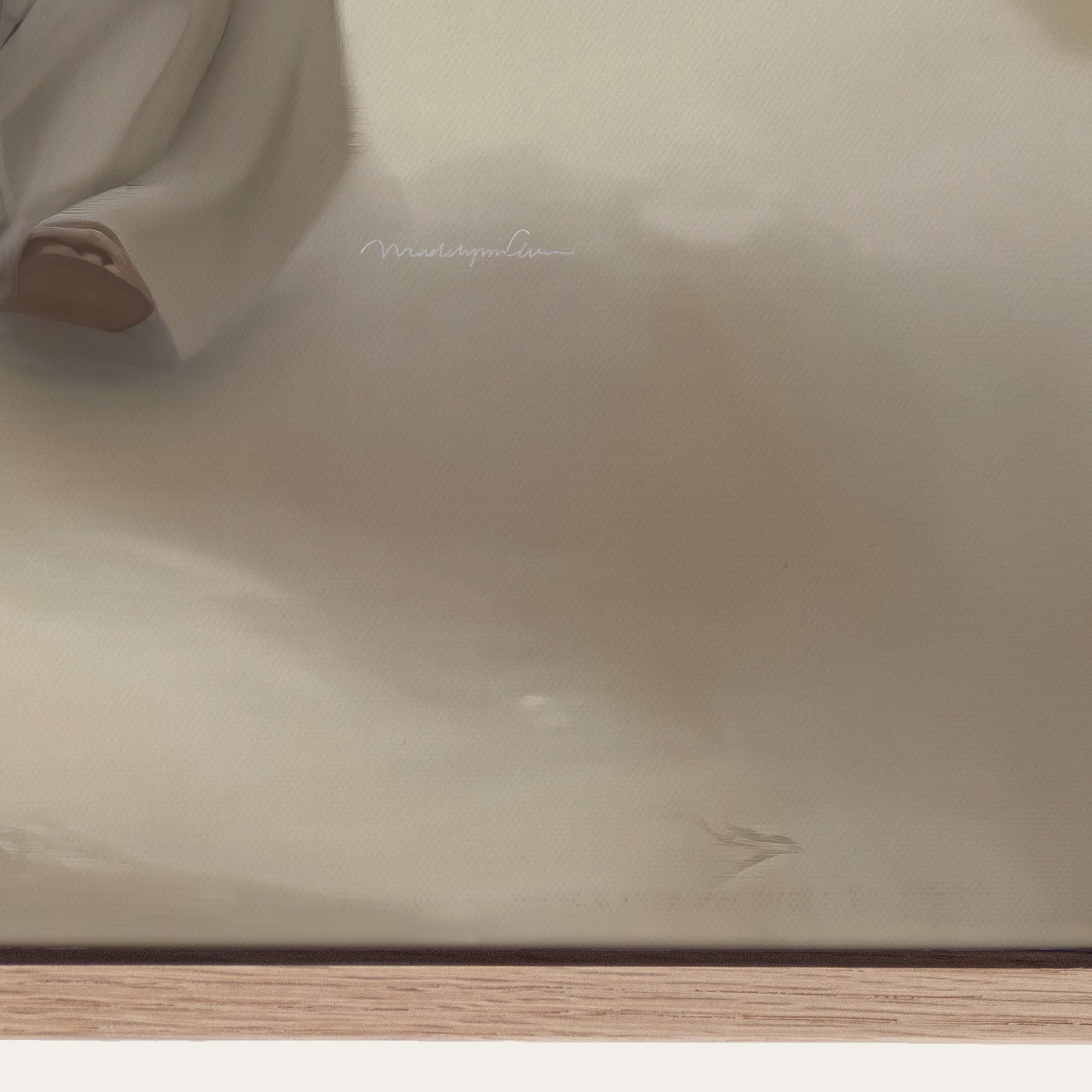 Close-up of a beige fabric with a brand name on a wooden surface. 