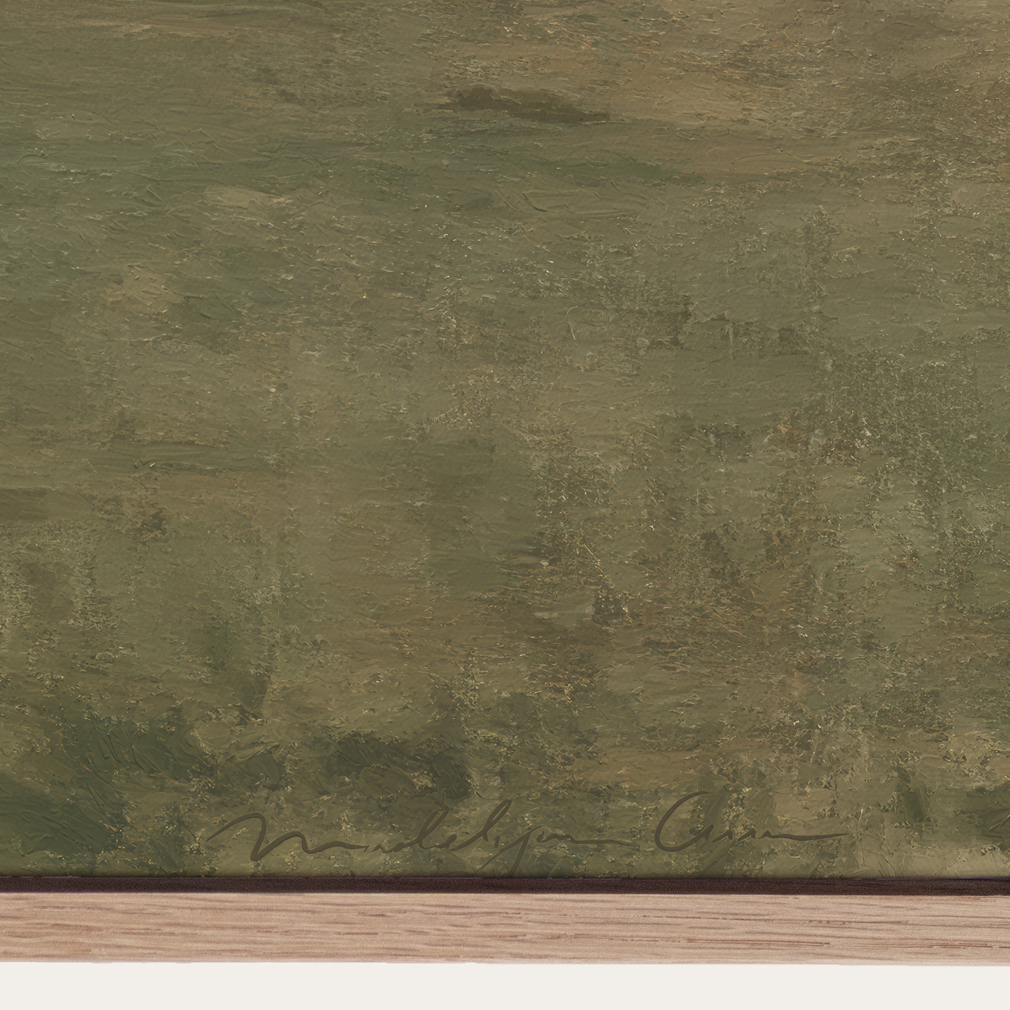 Textured green surface with a signature at the bottom right corner 