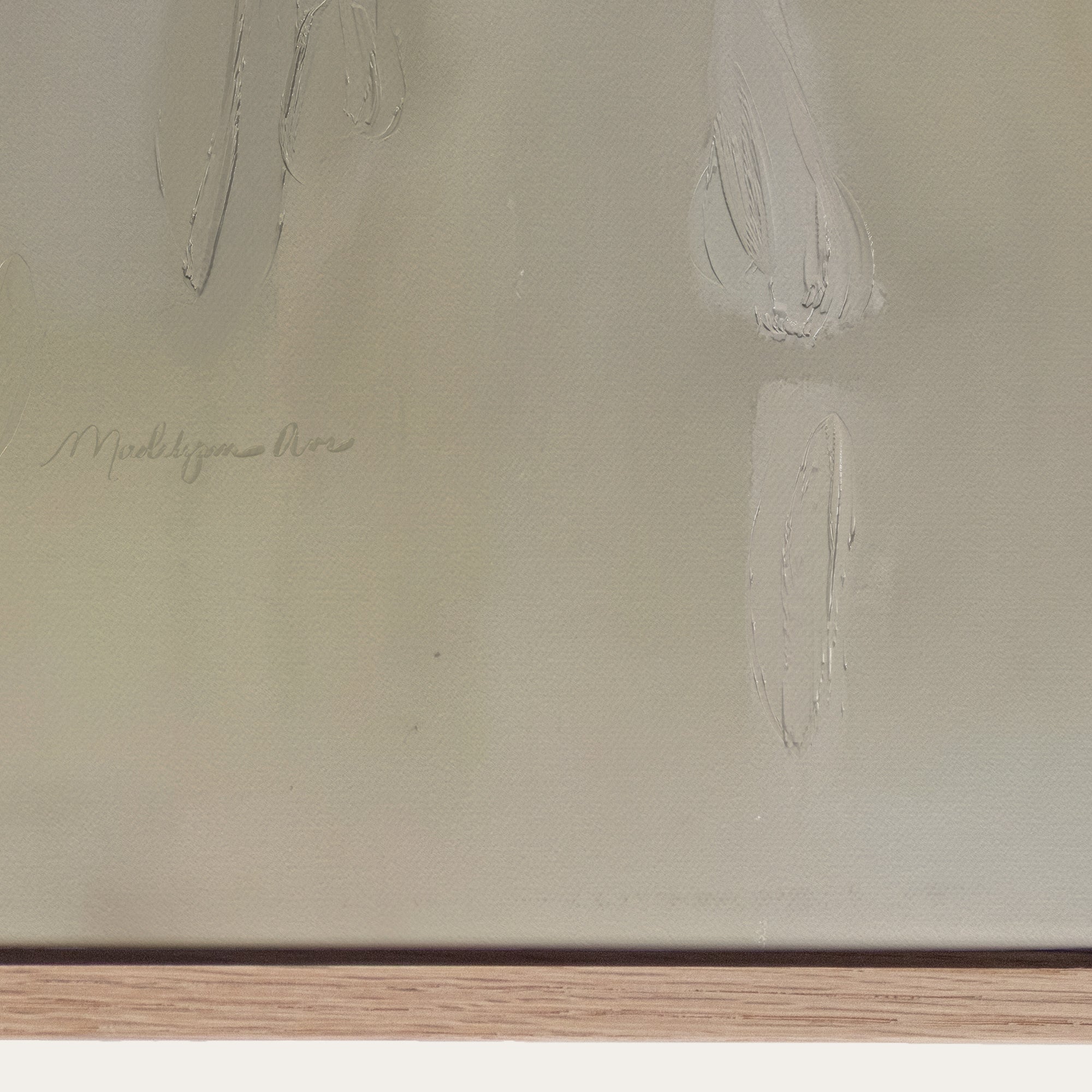 Close-up of a textured beige surface with a signature at the bottom left corner. 