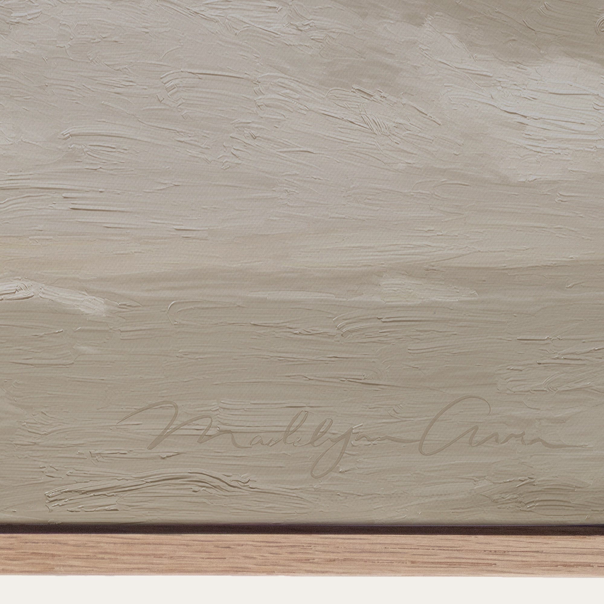 Textured beige surface with a signature at the bottom right corner 