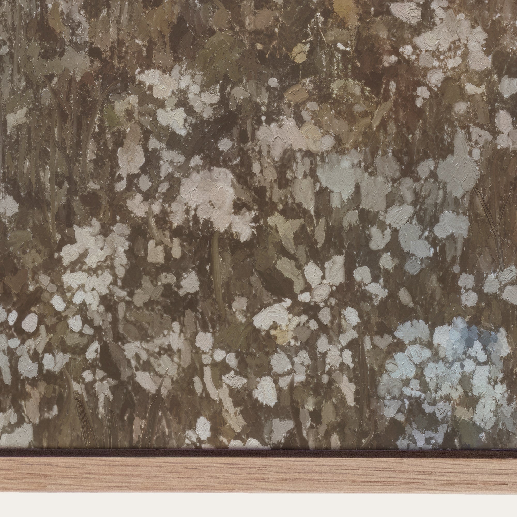 Floral patterned wallpaper with a mix of brown, beige, and white colors on a wooden surface. 