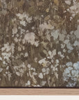 floral patterned wallpaper with a mix of brown, beige, and white colors on a wooden surface. 