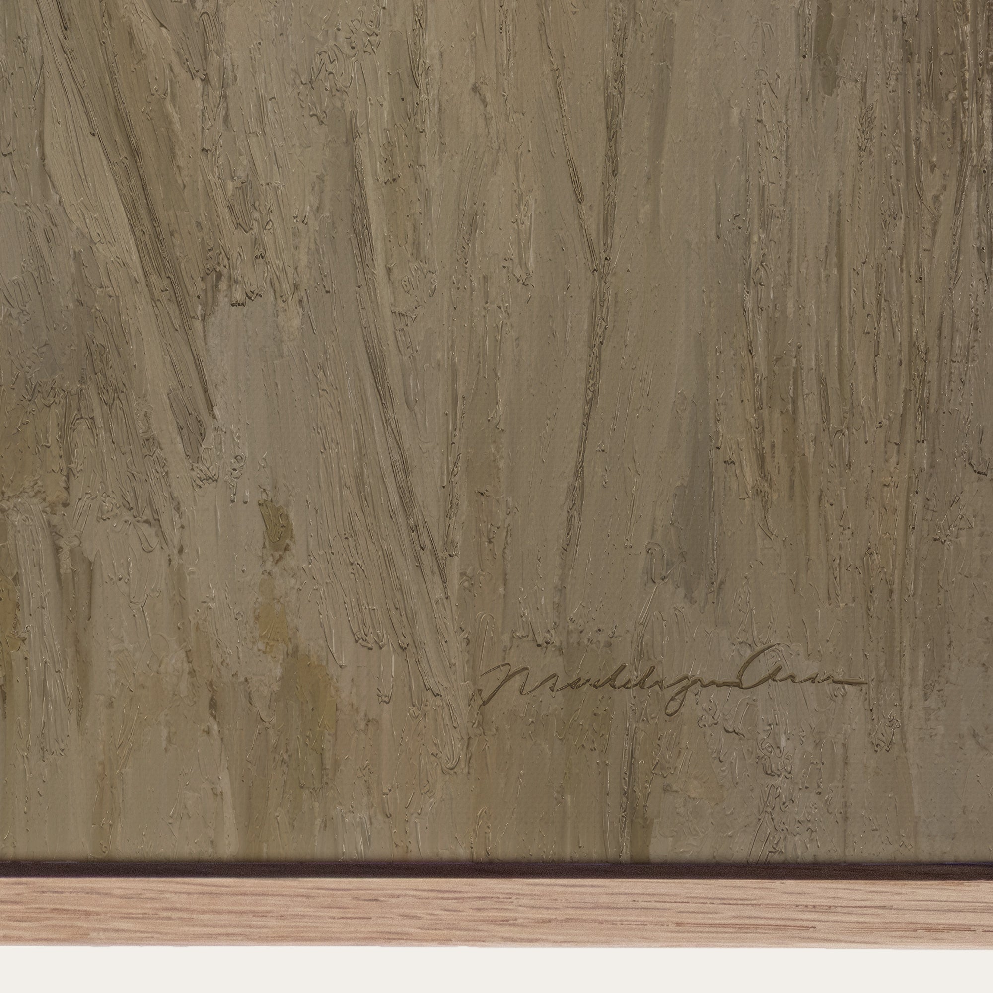 Close-up of a textured brown surface with a signature at the bottom right corner. 