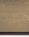 close-up of a textured beige surface with a signature at the bottom right corner. 
