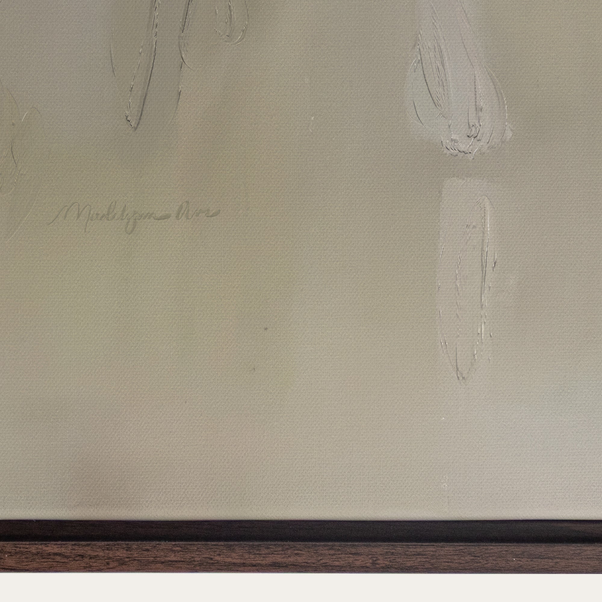 Close-up of a textured beige surface with an artist's signature, likely from a painting. 