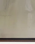 close-up of a textured beige surface with an artist's signature, likely from a painting. 
