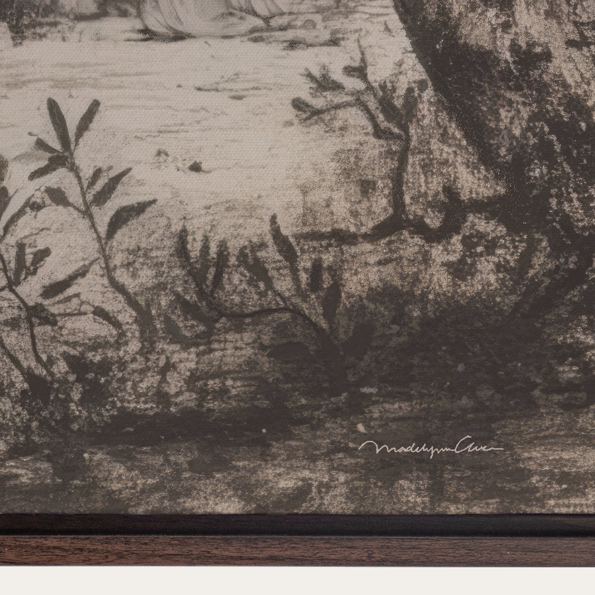 Close-up of a textured surface with engraved design and signature at the bottom right corner. 