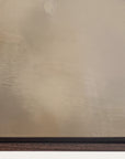 textured beige wall with a dark wood baseboard 