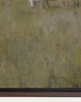 close-up of a textured green surface with a signature at the bottom right corner. 