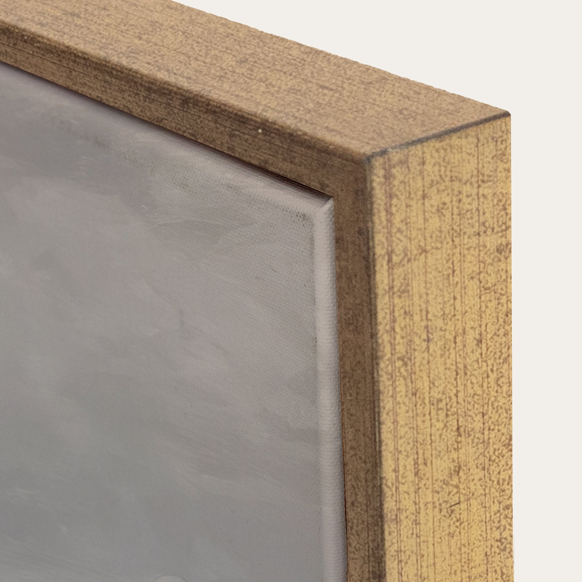 Close-up of a wooden frame corner with a gray background. 