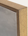 close-up of a wooden frame corner with a gray background. 