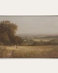 framed landscape painting of a person walking through a field with trees and a misty background. 