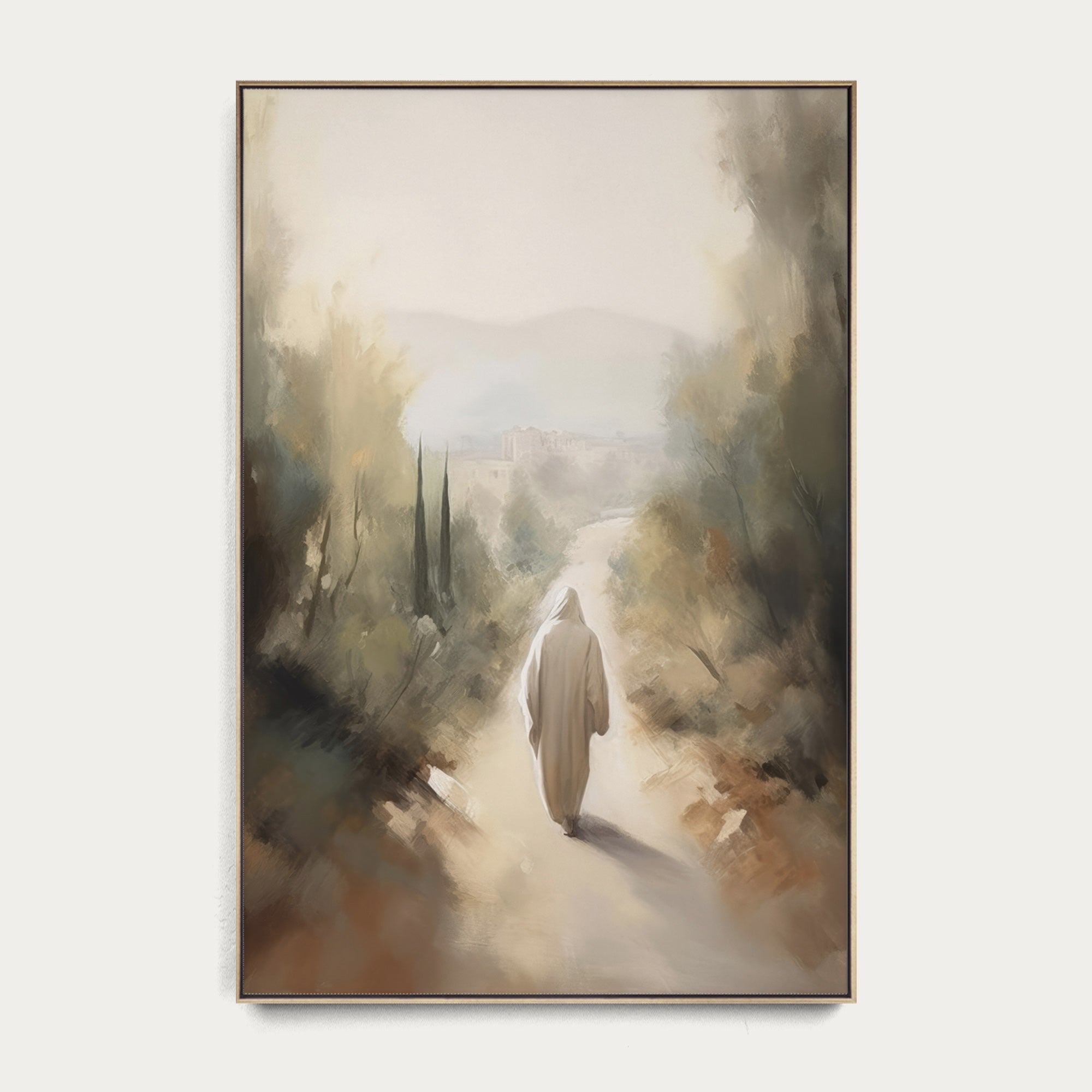 Framed artwork of a person walking down a misty path with trees on a white wall. 