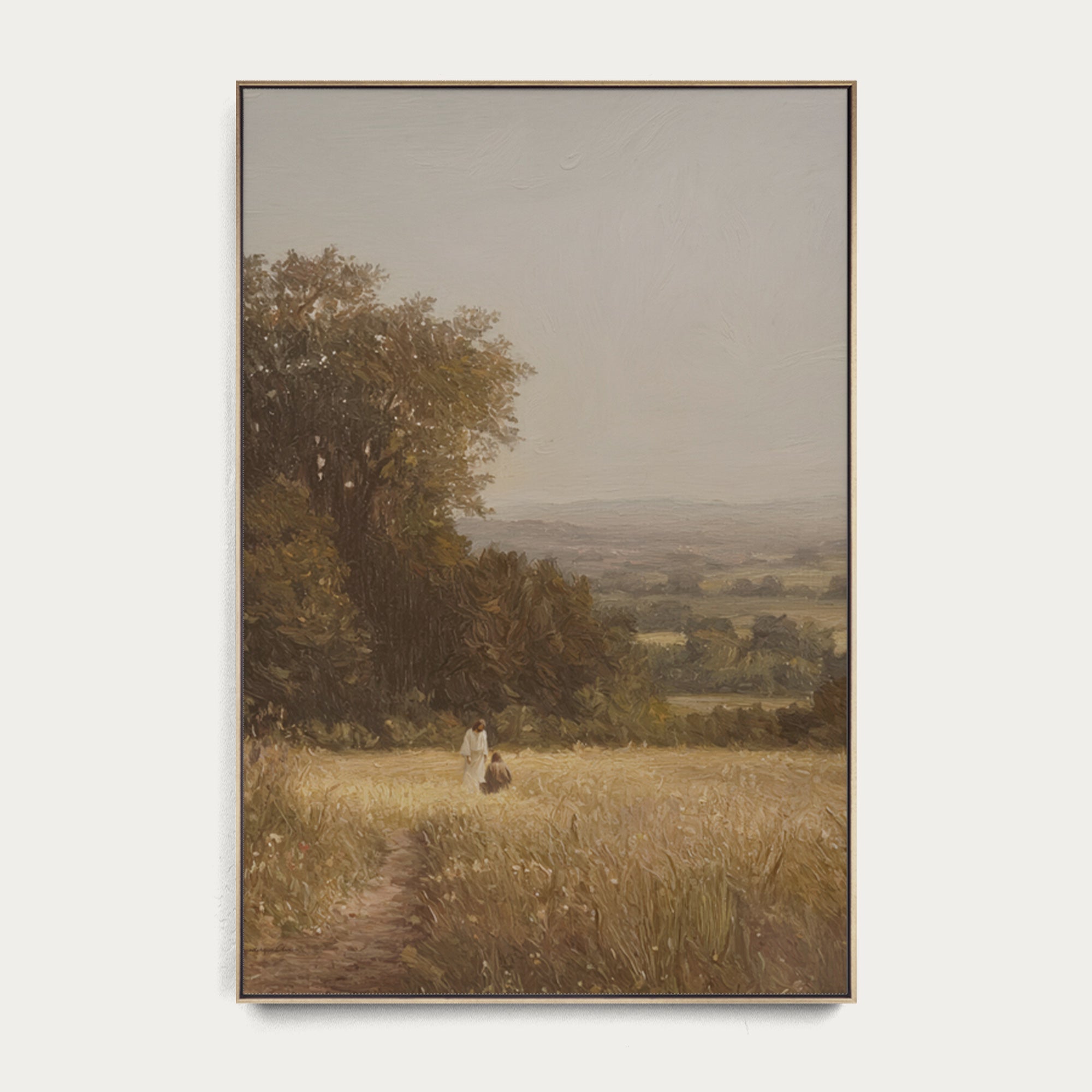 Framed painting of a landscape with a person walking on a path through a field. 