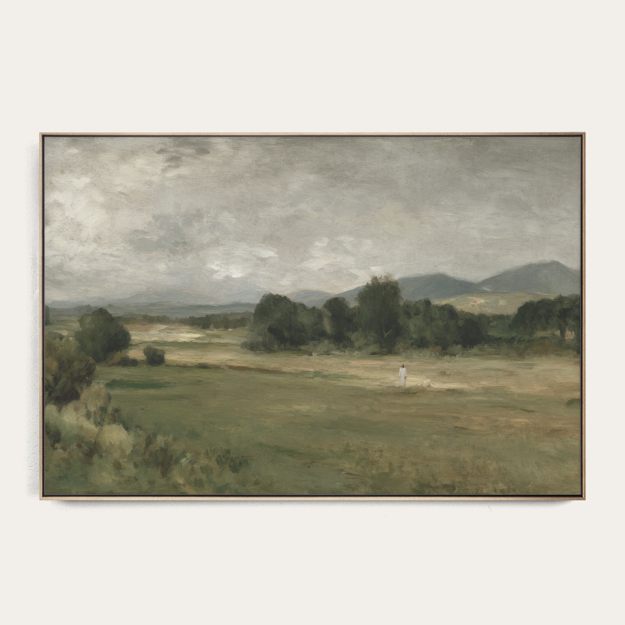 Framed painting of a landscape with a figure walking on a path. 