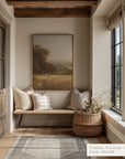 nook with a cushioned bench, framed artwork, and a woven basket with plants.