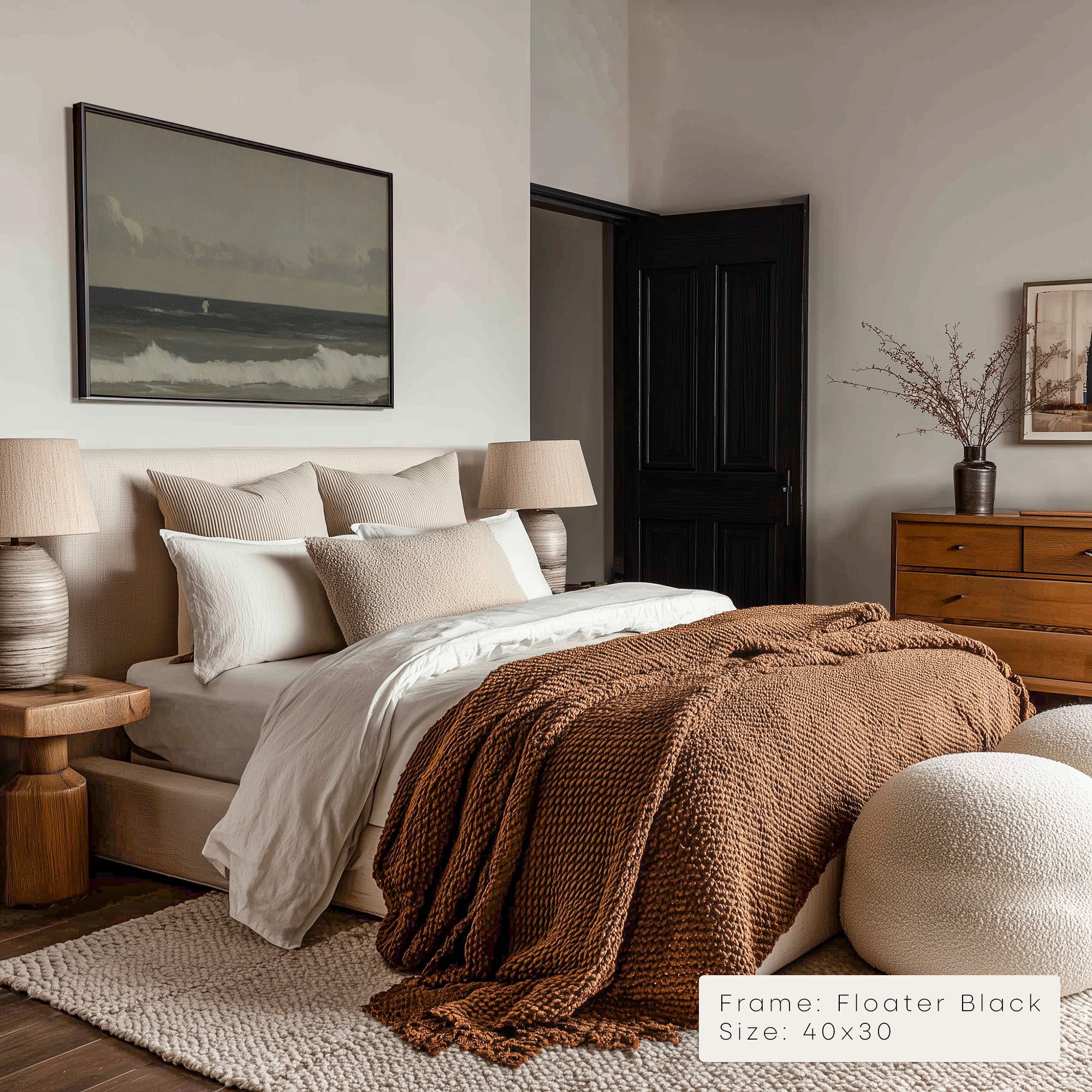 Cozy bedroom with a bed, lamp, and artwork on the wall.