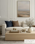 living room with a beige sofa, coffee table, and wall art