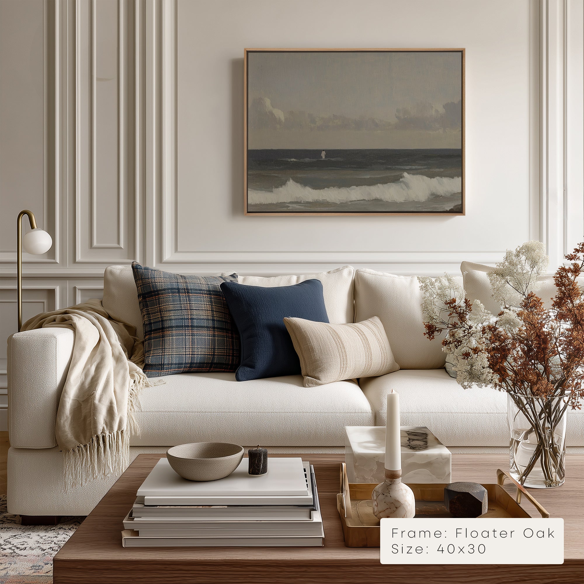 Modern living room with a white sofa, decorative pillows, and a framed artwork on the wall.