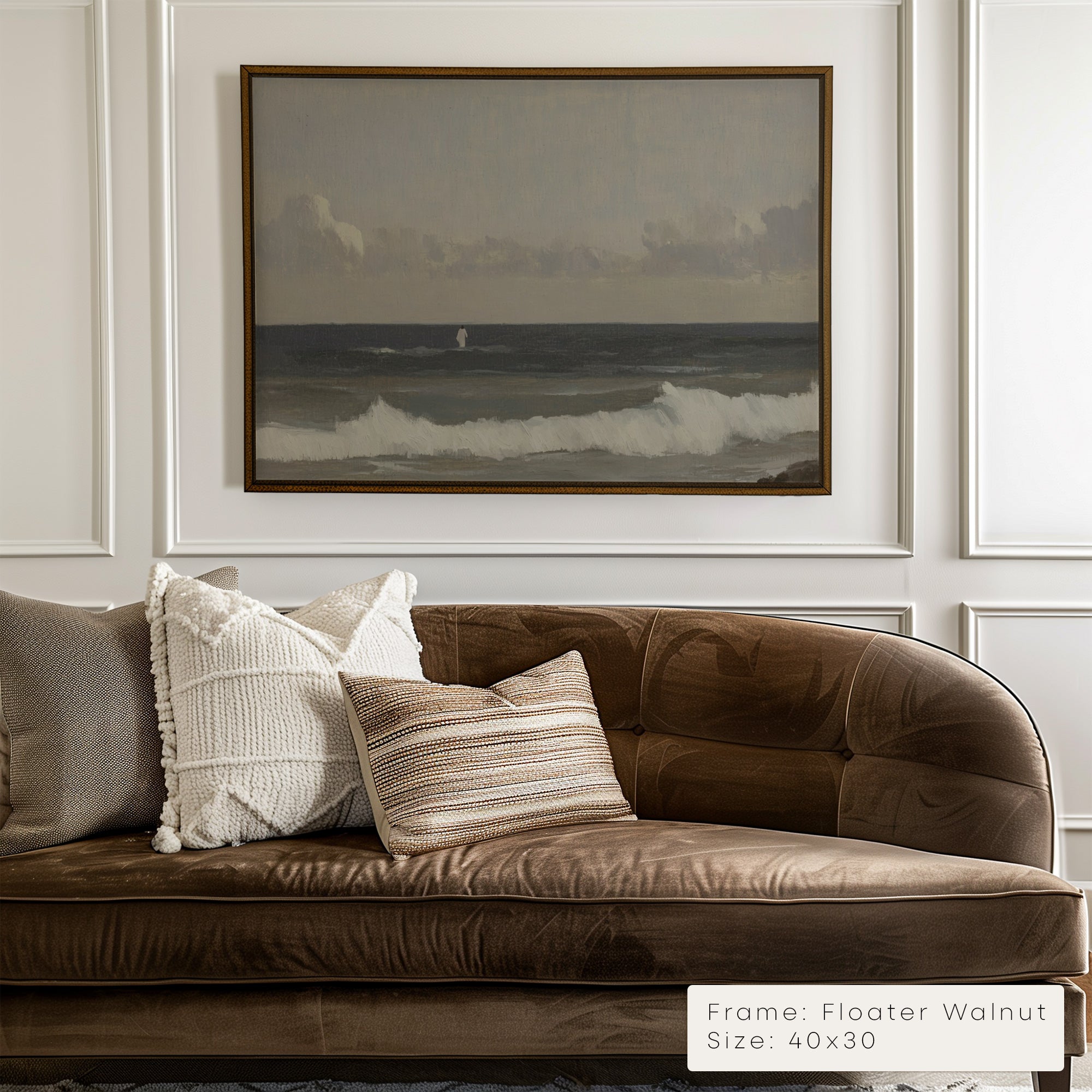 Brown sofa with decorative pillows in a room with a framed landscape painting on the wall. 