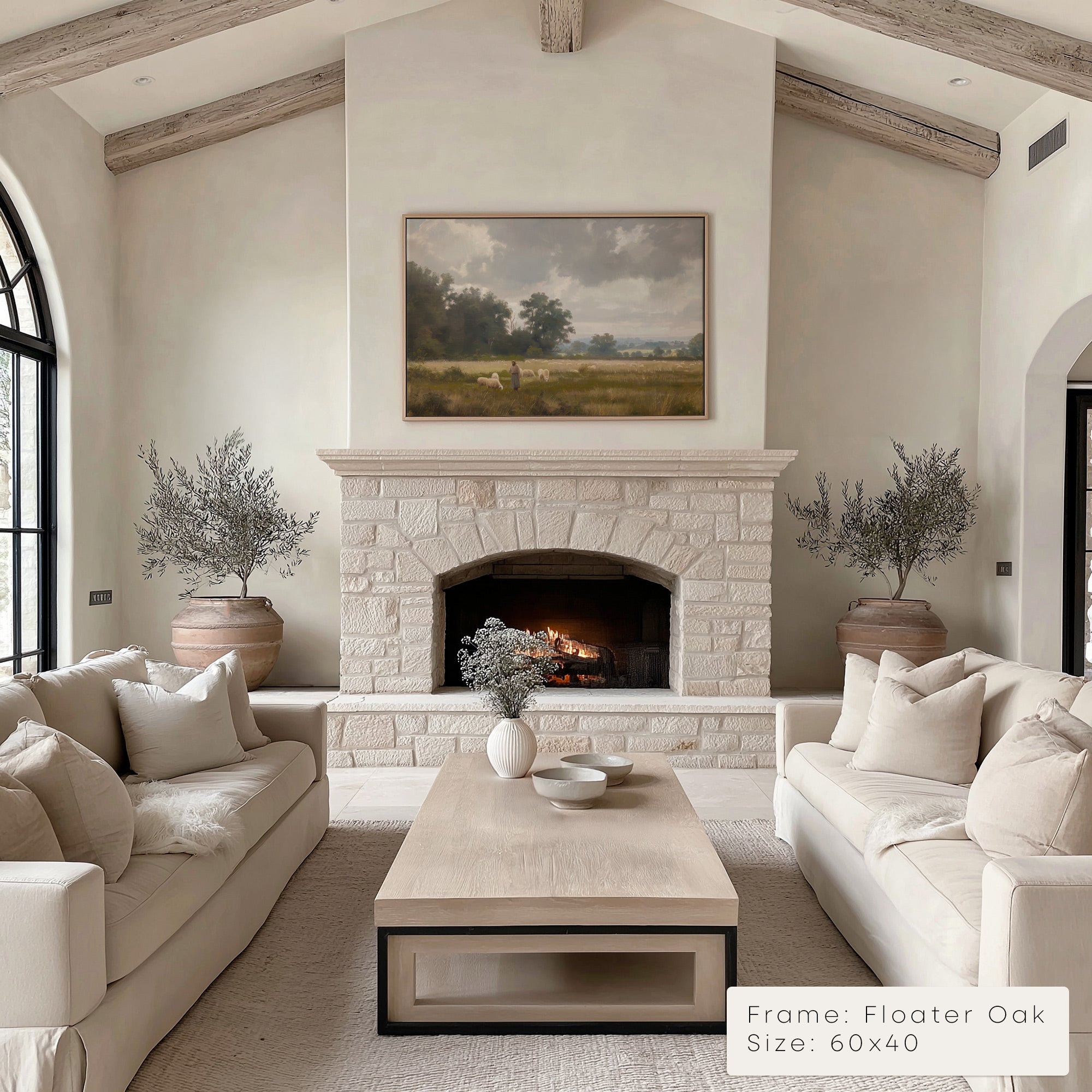 Living room with stone fireplace, beige sofas, and a painting above the fireplace. __lifestyleImage