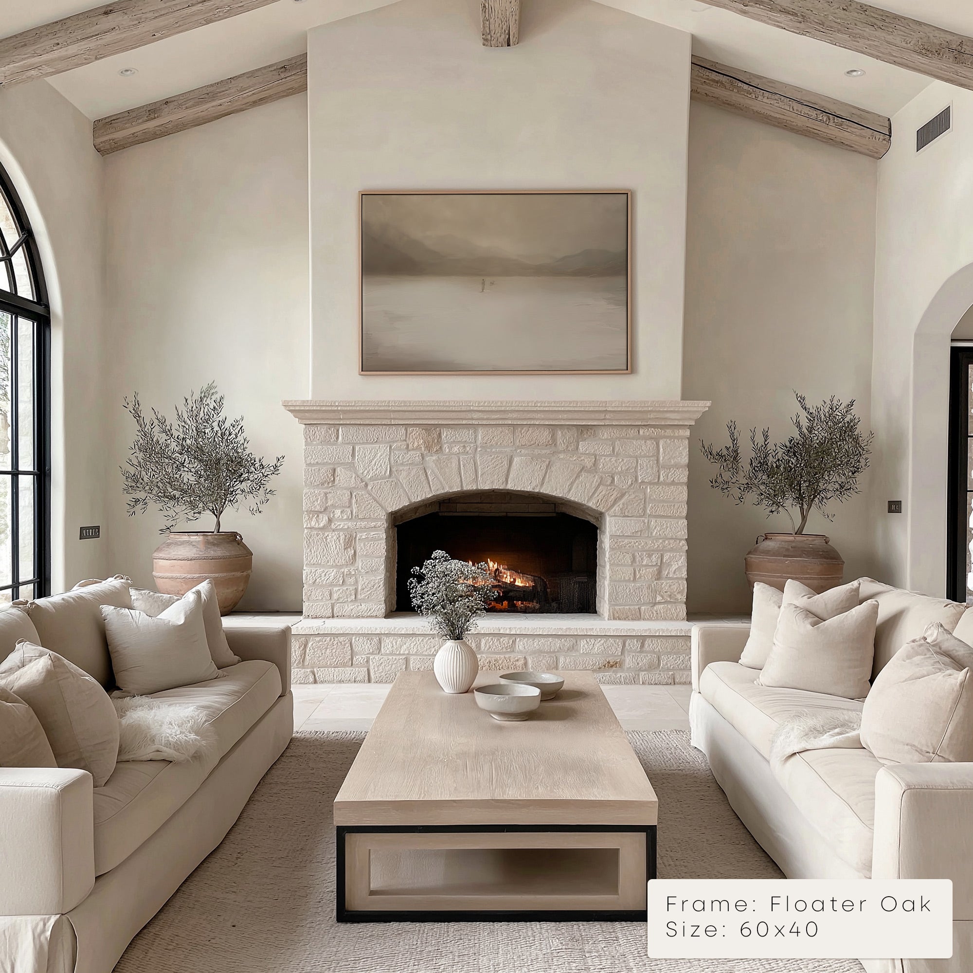 Living room with stone fireplace, beige sofas, and a coffee table.