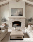 living room with stone fireplace, beige sofas, and a coffee table. __lifestyleimage