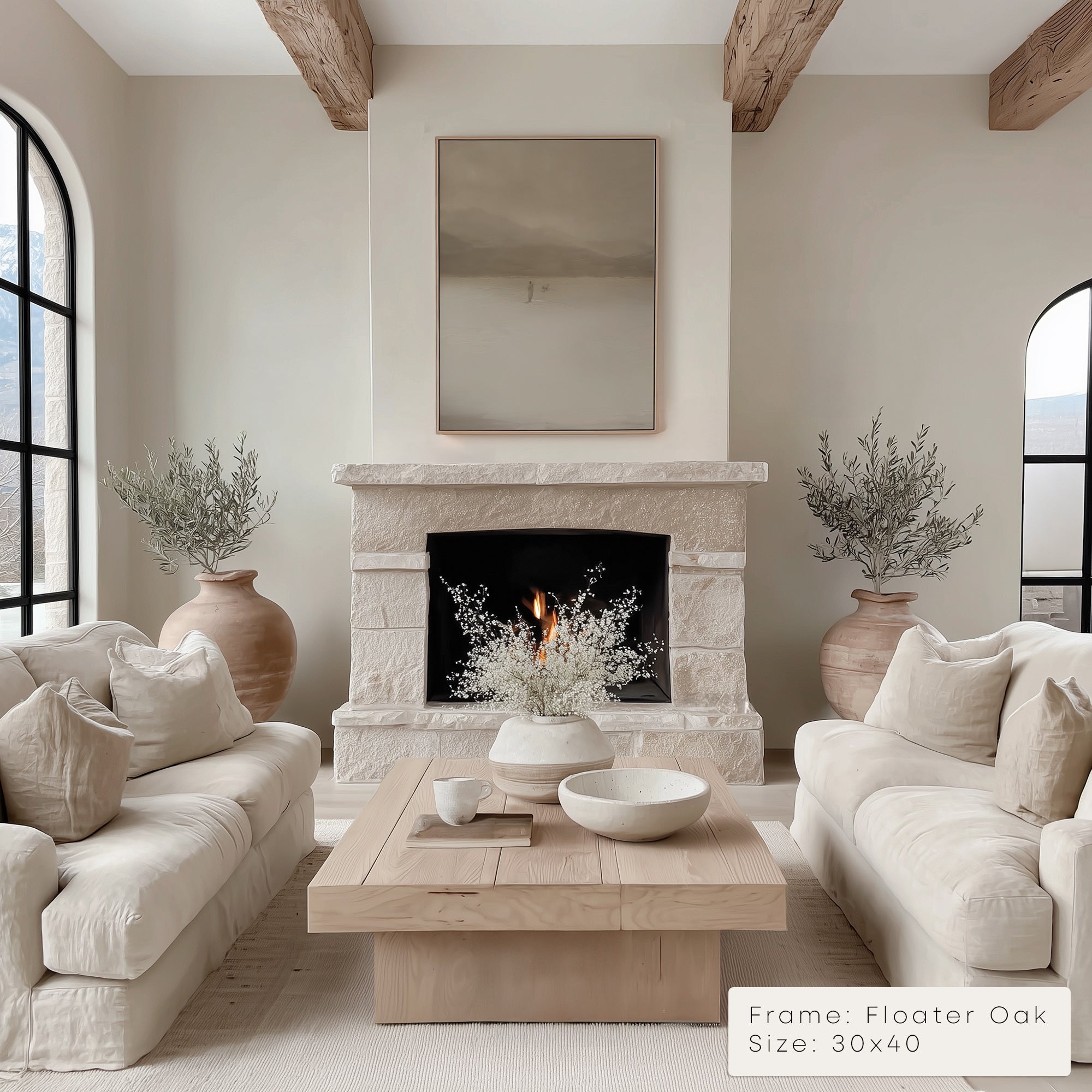 Living room with a fireplace, white sofas, and decorative elements.