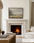 living room with a fireplace, framed landscape painting, and beige sofa.