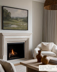living room with fireplace, white armchair, and framed landscape painting.