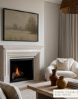 living room with fireplace, white armchair, and framed artwork on the wall.