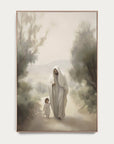 framed artwork of a woman in a white robe walking with a child through a misty forest. 