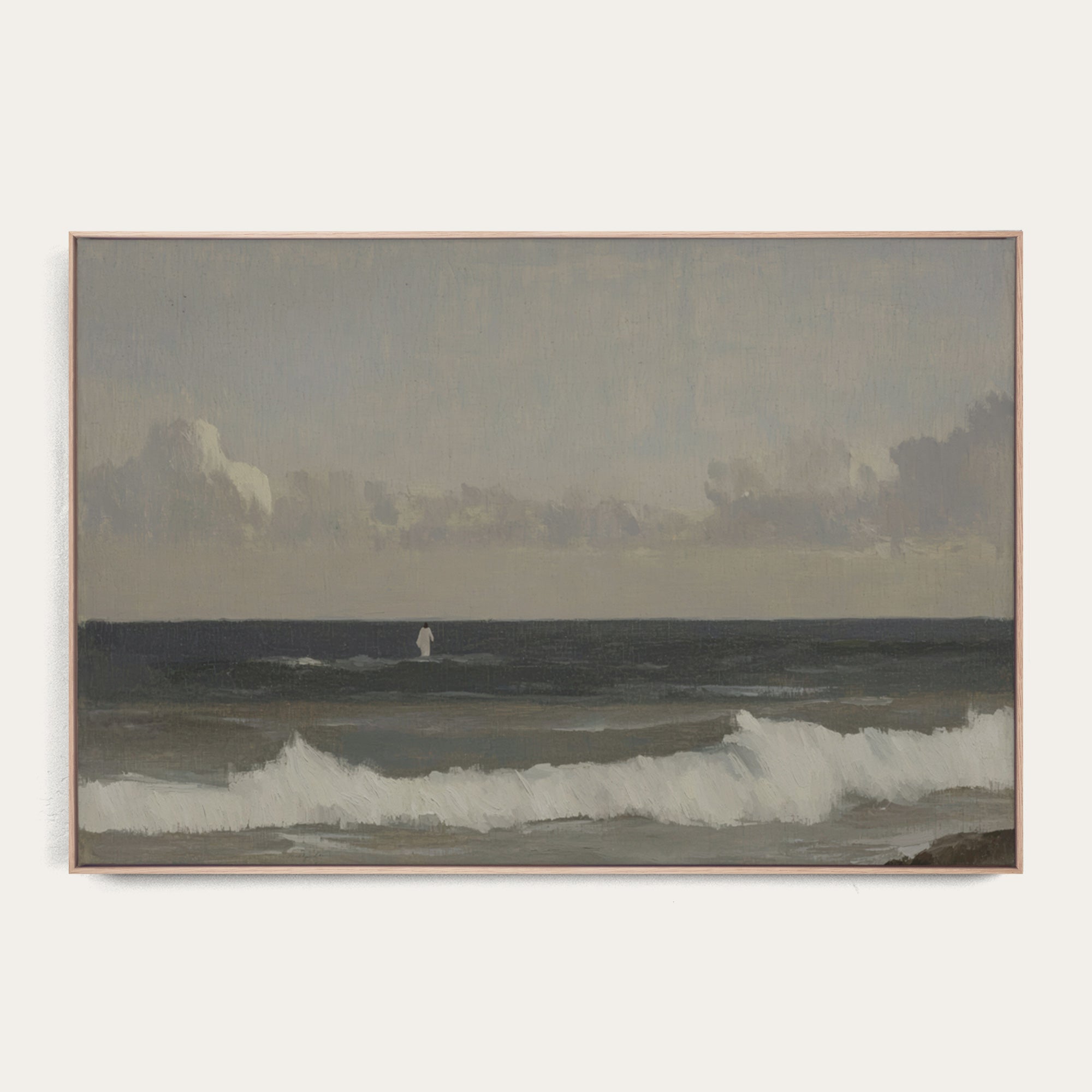 Framed artwork of a coastal scene with waves and a distant figure on a white background 