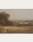 framed landscape painting of a person walking through a field with trees and a misty background. 