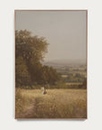 framed painting of a landscape with a person walking on a path through a field. 