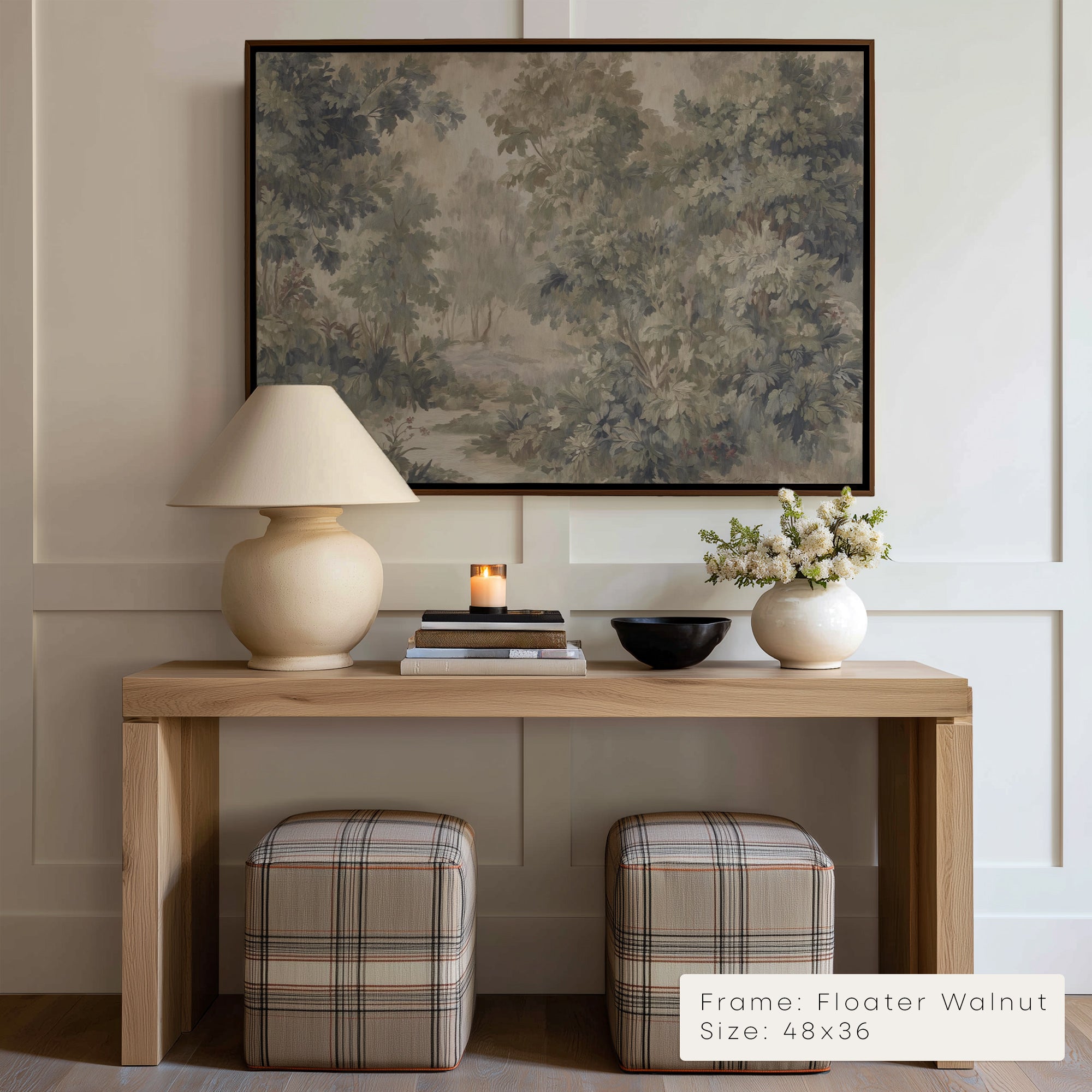 Wooden console table with lamp, books, and decorative items against a wall with a framed painting.