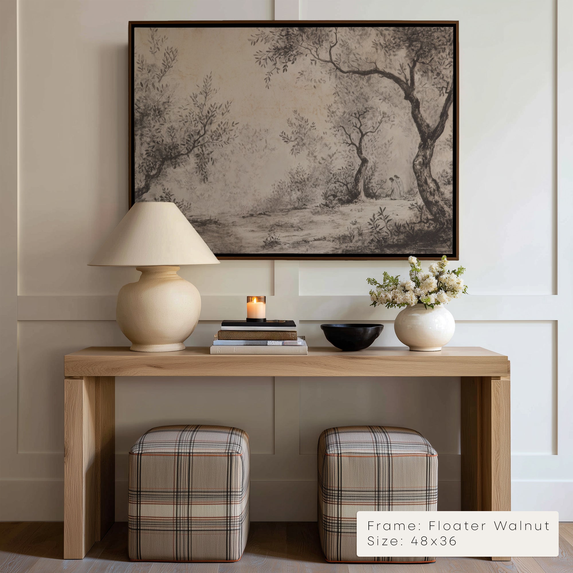 Wooden console table with lamp, books, and decorative items against a wall with framed artwork.