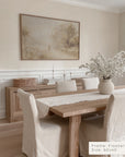 dining room with wooden table, chairs, and a framed painting on the wall.