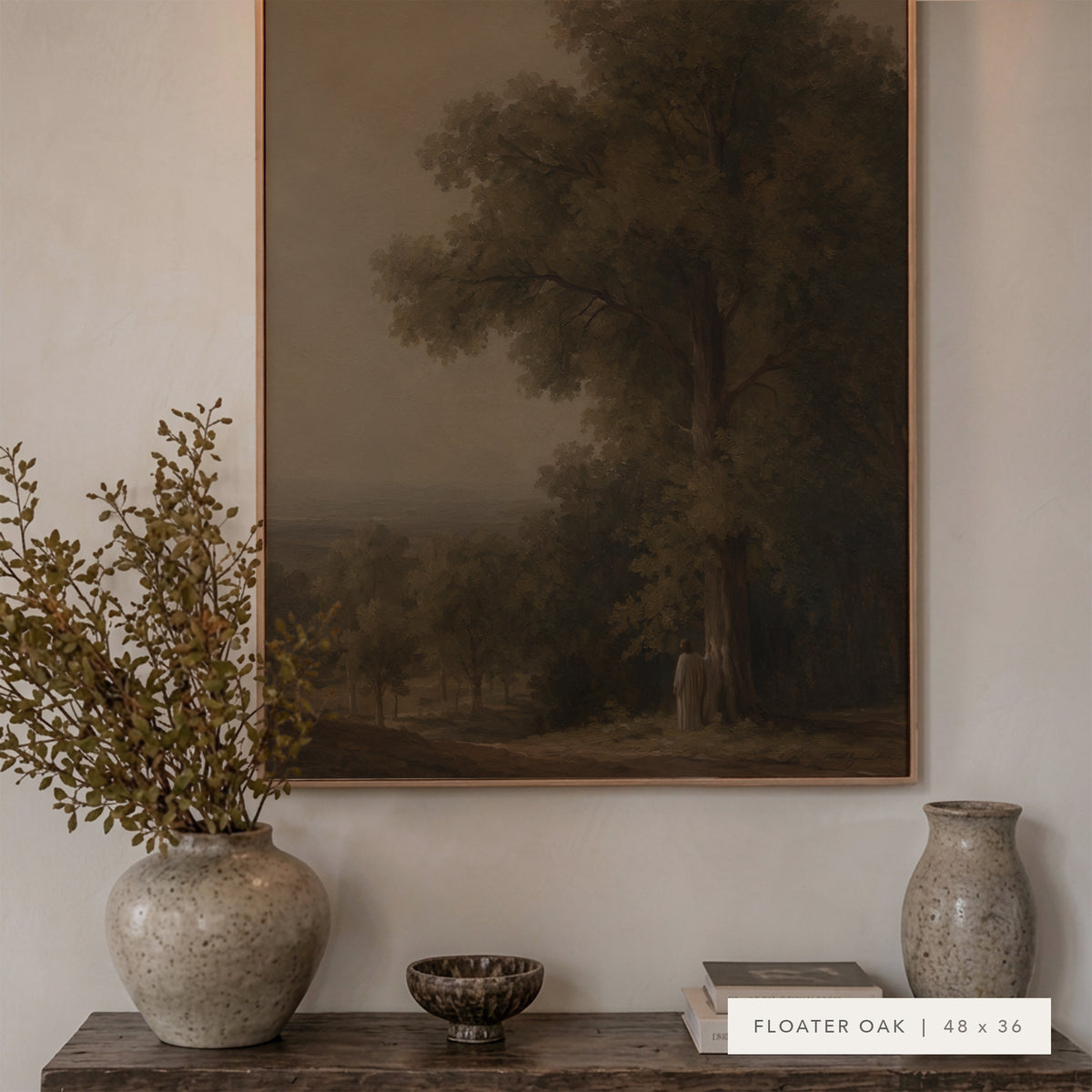 A framed landscape art print featuring a large tree in a muted forest scene, displayed on a wall above a wooden console table with ceramic vases and a small bowl. The print is labeled 'FLOATER OAK | 48 x 36'.