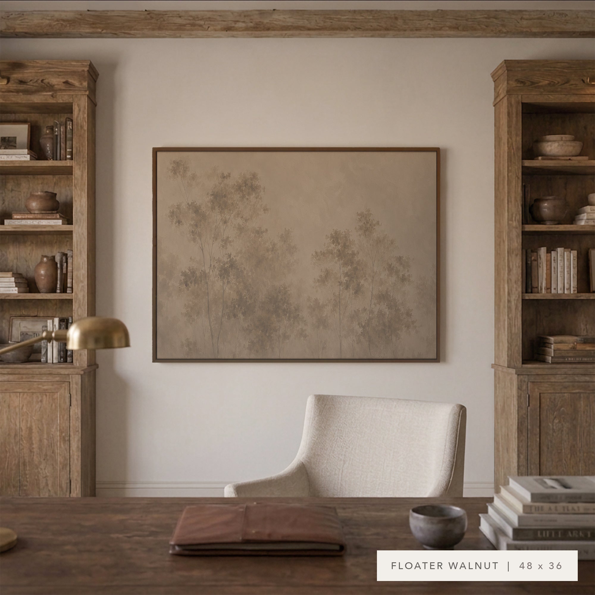 A framed art print featuring a minimalist beige and brown botanical design, displayed on a white wall in a styled home office setting with wooden bookshelves, a desk, and a chair.