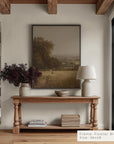 living room with wooden console table, framed landscape painting, and decorative items.
