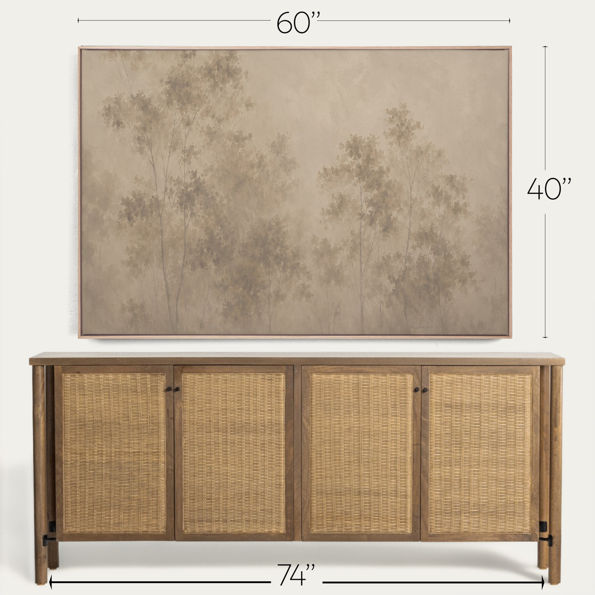 A framed wall art print showing a muted beige and brown forest scene, displayed above a wooden sideboard with woven cane doors. Dimension labels indicate 60 inches wide, 40 inches tall, and the sideboard 74 inches wide. 
