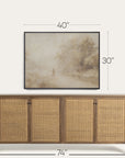 wooden sideboard with wicker doors and framed artwork above on a white background 